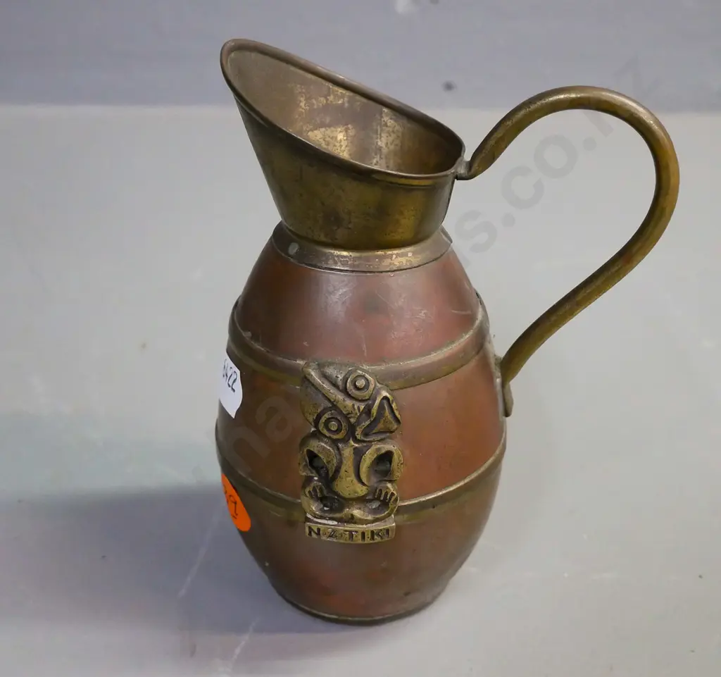 brass and copper jug with 'NZ Tiki' and applied brass Tiki, some dents. H-130, D-100 Image 1++