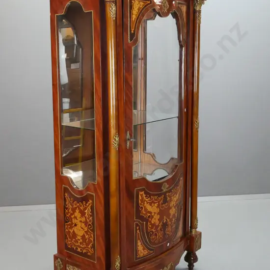 French Empire-style kingwood veneer vitrine with fruitwood inlay panels with single bowed door, glazed sides, mirrored