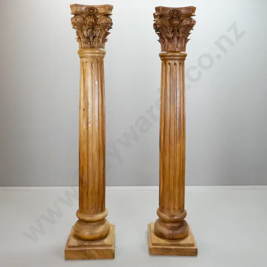 pair of Indonesian mahogany Romanesque columns on square stepped base with carved Corinthian style capital on fluted