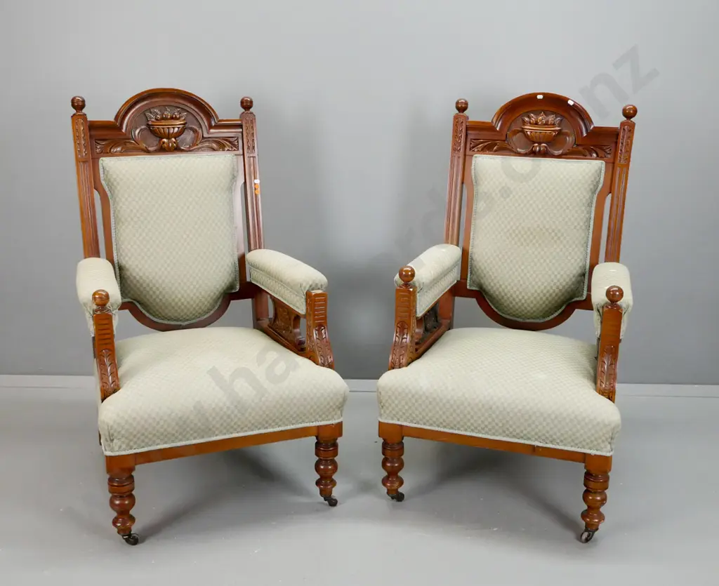 pair of vintage upholstered kauri armchairs with shaped carved back, fluted and foliate carved arms, turned legs - one Image 1++