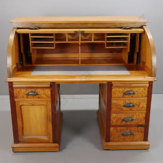 colonial rimu, rewa-rewa and mottled kauri double pedestal cylinder top desk with drawer front, hinged side panels, 5
