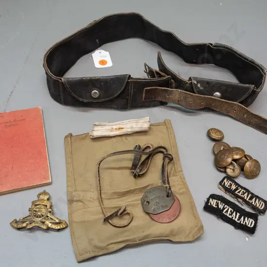 WW1-era New Zealand military items - artillery cap badge, brass buttons, dog tags (name RD Miller) etc and a leather