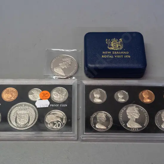 two plastic cased New Zealand 1972 proof coin sets and a NZ Royal Visit 1970 Cook Islands dollar