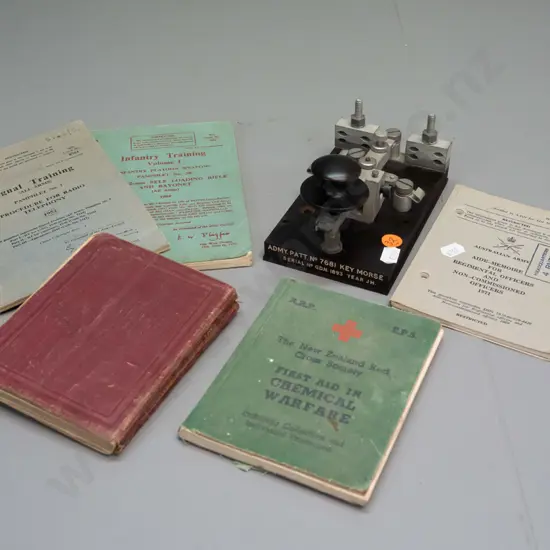 assorted military handbooks - signals training, first aid & chemical warfare, infantry training - and a morse key H-90