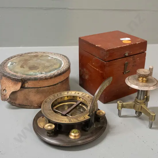 mahogany cased Baird & Tatlock spherometer and a RetroBrass Collectables reproduction sundial compass with leather case.