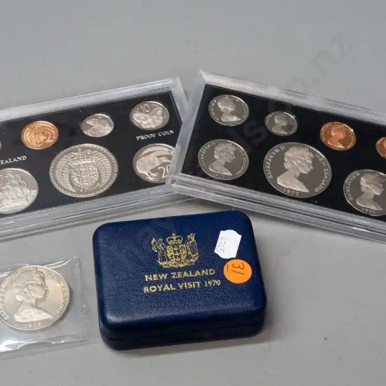two plastic cased New Zealand 1972 proof coin sets and a NZ Royal Visit 1970 Cook Islands dollar