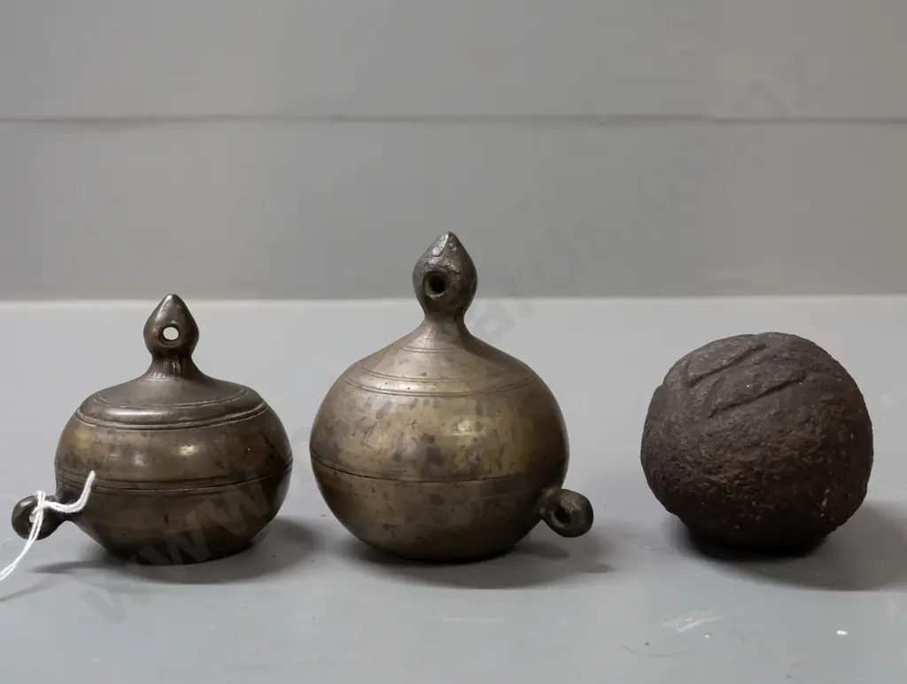 2 small gourd shaped metal storage canisters with lift off lids with strap or cord lugs on sides and a small carved Image 1++