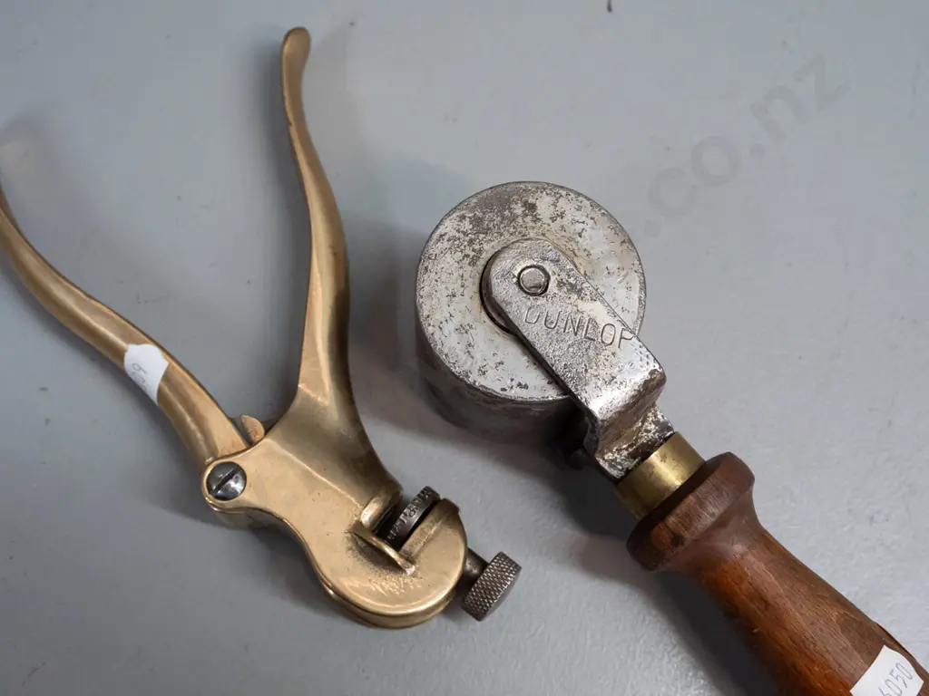 vintage wood-handled roller with heavy steel wheel, marked Dunlop, and a crimper or hand press marked Eclipse No. 77 Image 1++