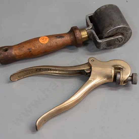 vintage wood-handled roller with heavy steel wheel, marked Dunlop, and a crimper or hand press marked Eclipse No. 77