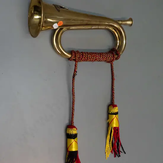 brass ornamental bugle with tassels and cord, RNZ or English field artillery cannon emblem - some fraying to cord L-290