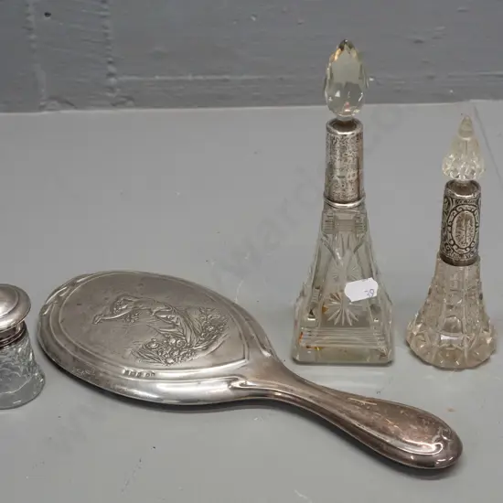 4 pieces of sterling silver - dressing table mirror, 3 cut glass scent bottles, all with some chips to glass stoppers,
