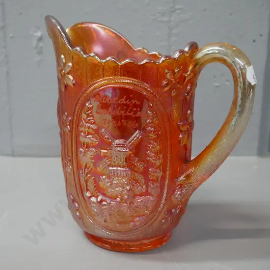carnival glass orange lustre jug with 'Dunedin Exhibition 1925-26' engraved. H-160 W-160