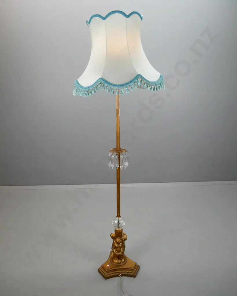 gilt finish metal standard lamp with fluted column, centre knot w/ hangiin lustres, 3 putti holding a cut crystal sphere Image 1++