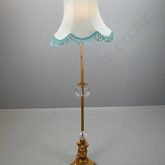 gilt finish metal standard lamp with fluted column, centre knot w/ hangiin lustres, 3 putti holding a cut crystal sphere