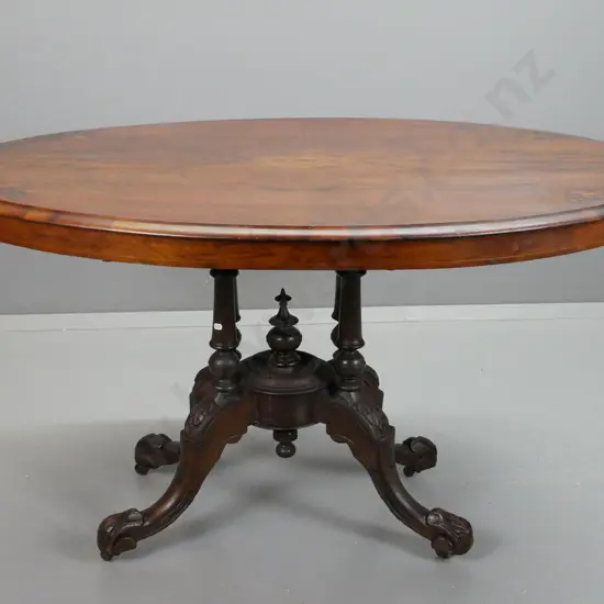Victorian walnut oval loo table on 4-point cathedral base, stringing and inlay to top, carved legs, working tilt