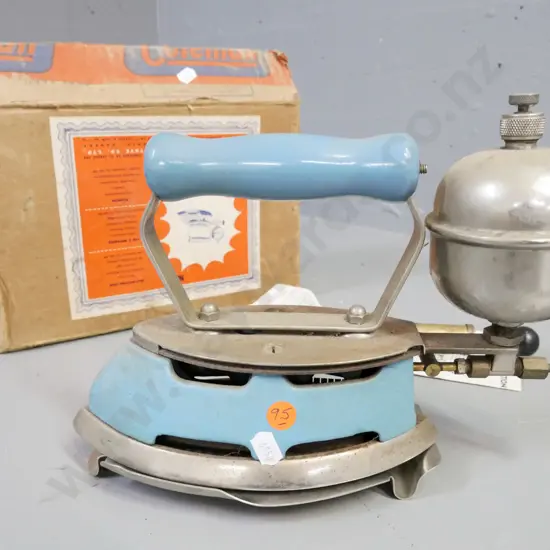 boxed Coleman self-heating iron, made in Canada. Includes operating manual, small pump, trivet. Iron H-190 W-270