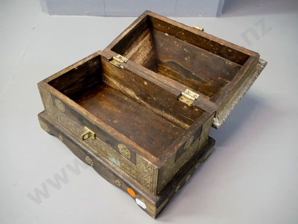 Asian hardwood Sarcophagus-shaped chest with hinged lid, white metal and brass binding, latch & applied decoration. Some Image 1++