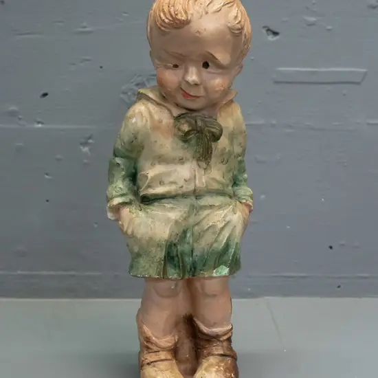 vintage plaster figure of a boy with comical expression - indecipherable mark to back of base, has touched up repair and