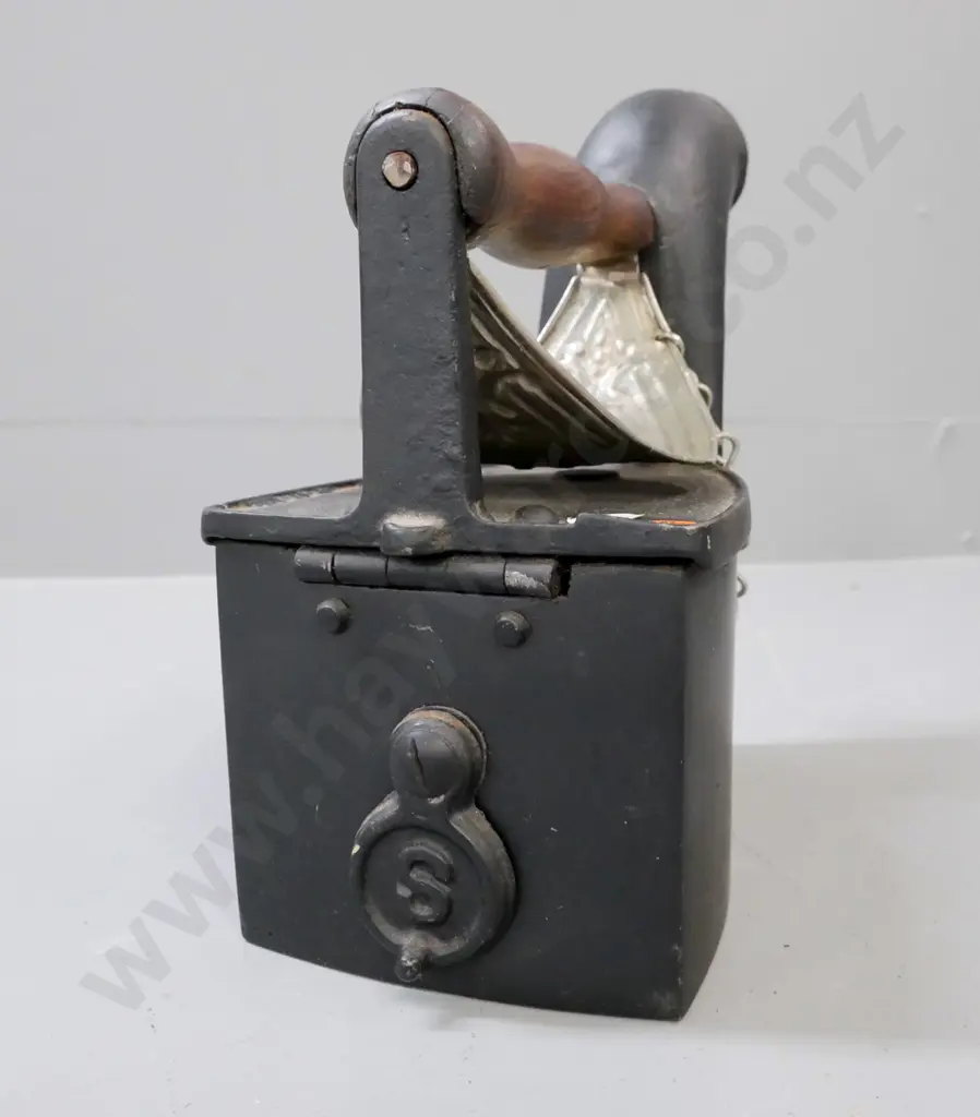 vintage cast metal coal iron w/ white metal heat shield, turned wooden handle, back latch with 'S' motif. Image 1++