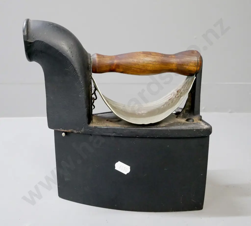 vintage cast metal coal iron w/ white metal heat shield, turned wooden handle, back latch with 'S' motif. Image 1++