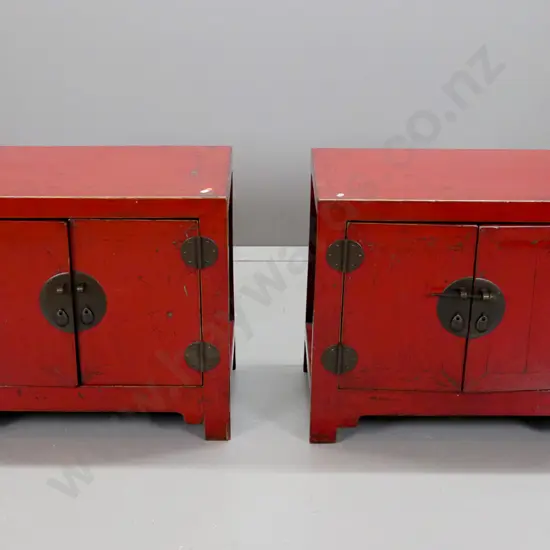 pair of Chinese red lacquered 2-door cupboards with circular metal plate and bar locks, circular hinges, restored