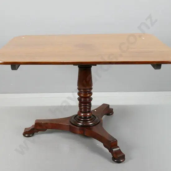 Georgian mahogany pedestal based tilt-top breakfast table with rectangular top, turned column on tri-form platform base.