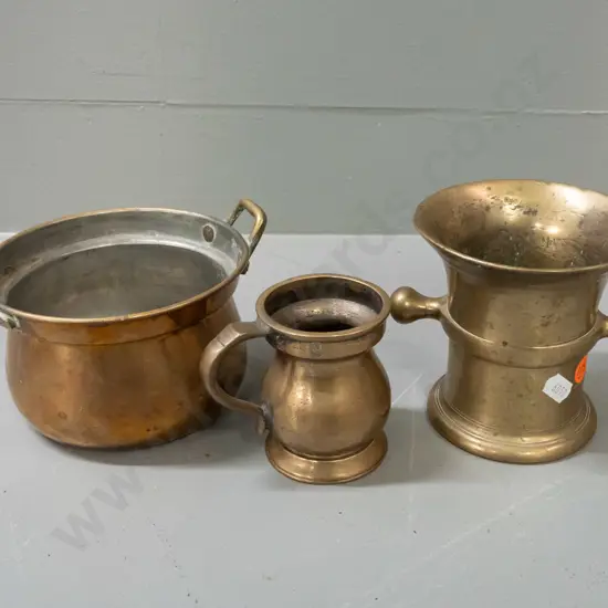 3 brass vessels - heavy cast mortar with side lugs H110, a handled gill measuring cup, and brass plated Indian double