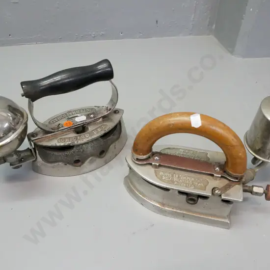 2x Vintage plated comfort irons, wooden handles. 1. International-brand, Chicago USA. 2. Imperial Brass Co, Chicago USA