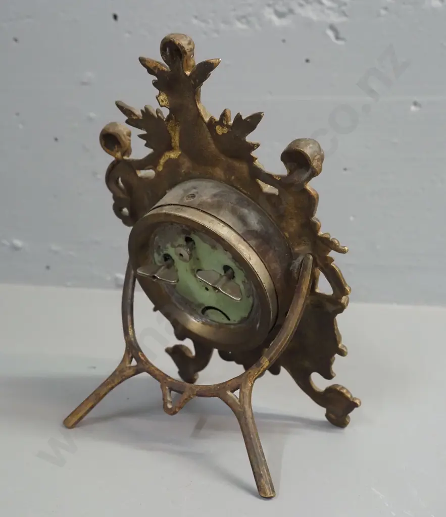 ornate vintage clock in gilded cast metal case with gilded metal and porcelain face, glow in the dark detail on hands, Image 1++