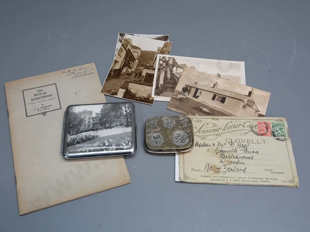 Cigarette case with Dunedin photo, Royal Albatross booklet, English spring loaded coin holder, and assorted postcards & Image 1++