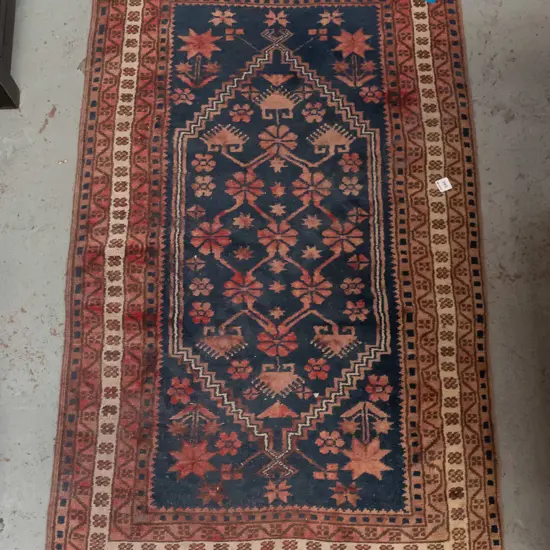 Persian style hand woven wool floor rug - reds and blues - fading and heavy wear to fringe L-1280 W-760