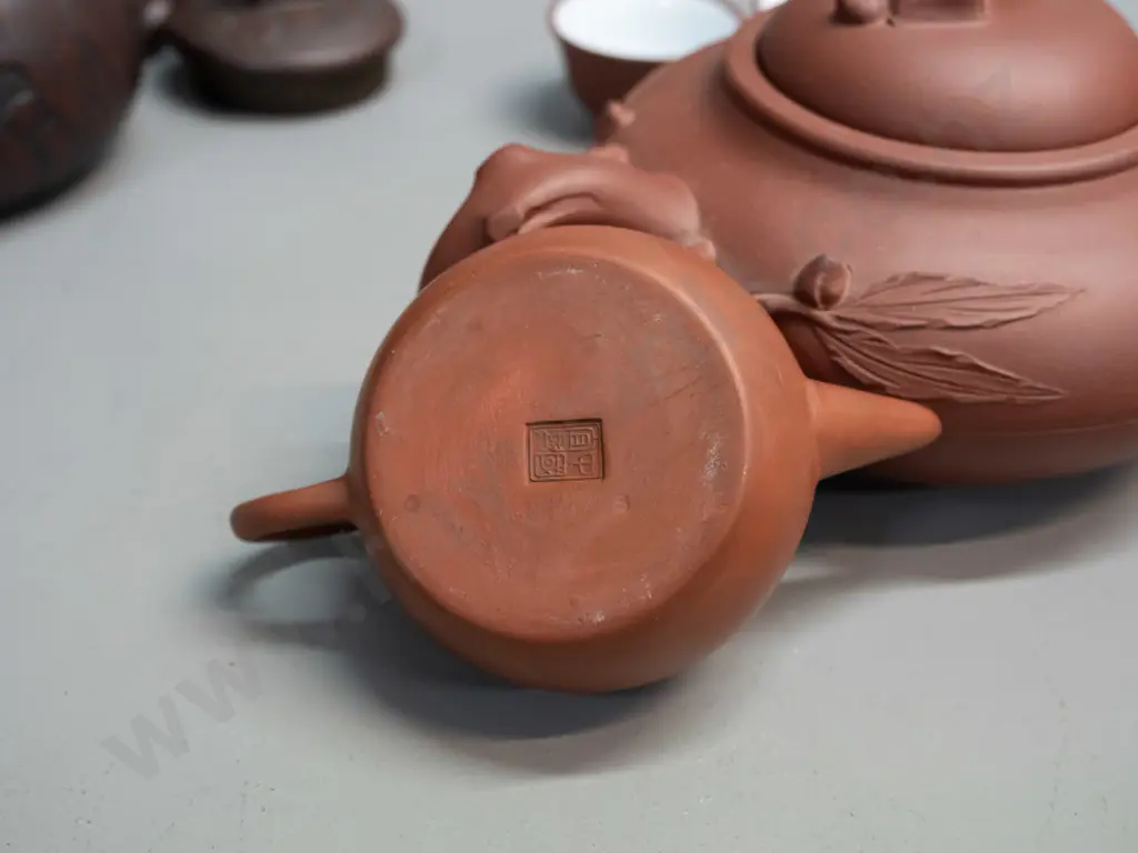 3 Chinese Yixing clay tea pots and 2 small tea bowls, one with leaf & tree forms has small chip in underside of lid, is Image 1++