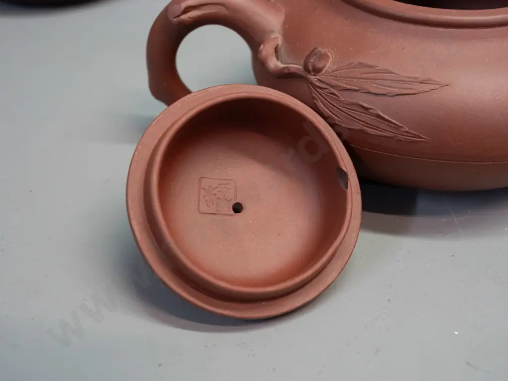 3 Chinese Yixing clay tea pots and 2 small tea bowls, one with leaf & tree forms has small chip in underside of lid, is Image 1++