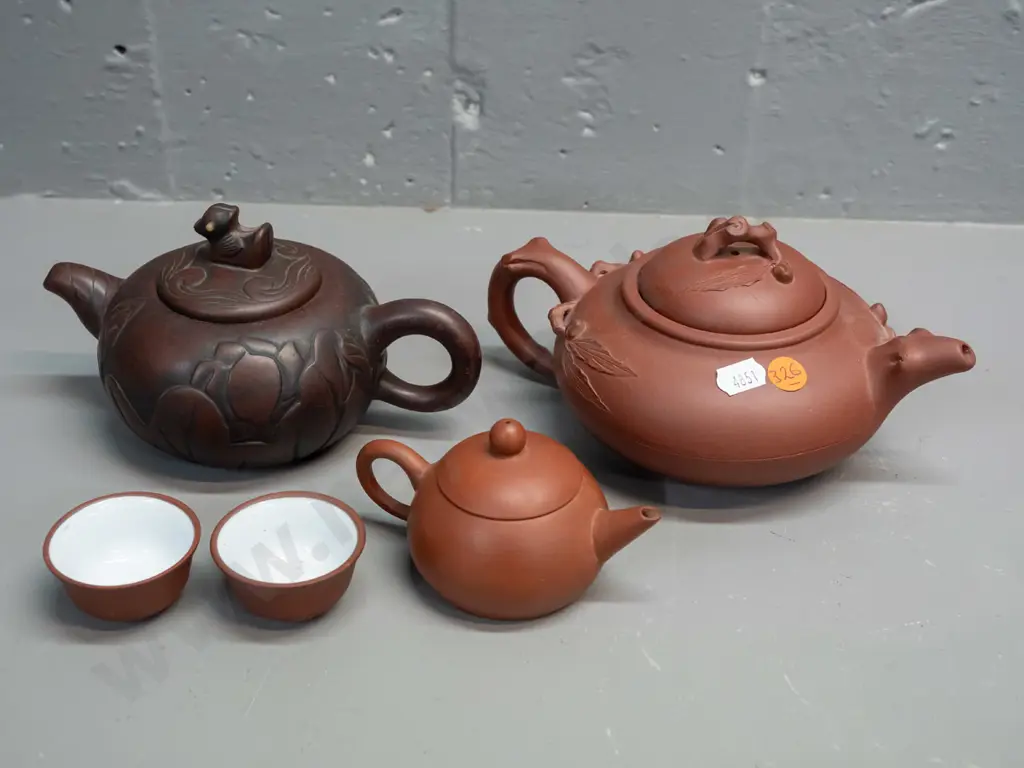 3 Chinese Yixing clay tea pots and 2 small tea bowls, one with leaf & tree forms has small chip in underside of lid, is Image 1++