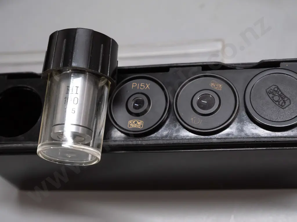 cased Kyowa Tokyo microscope in fitted wood case with 2 extra eyepieces and 1 objective in 2 plastic containers. Image 1++