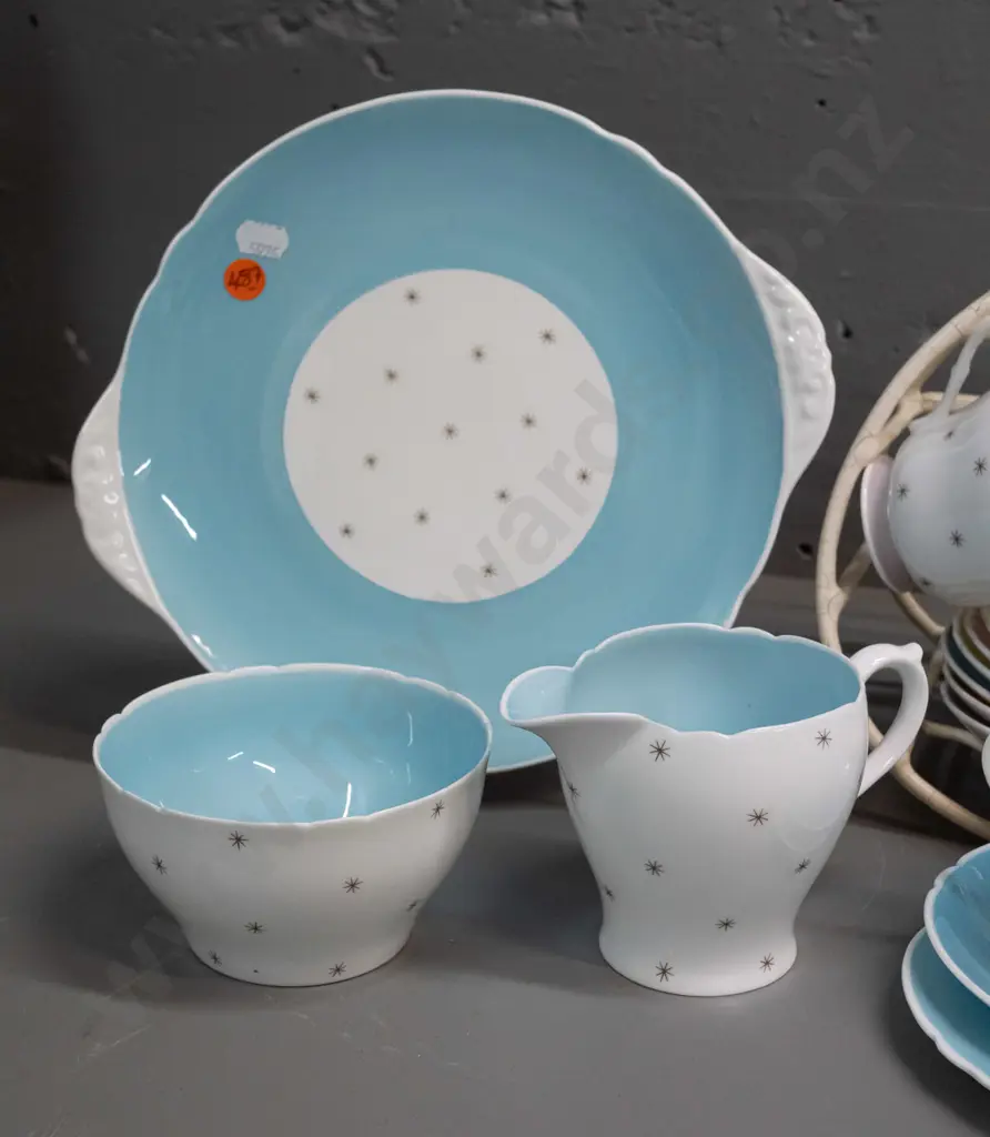 Shelley Pole Star tea ware - 9 trios, cake plate, cream & sugar with a plastic over wire stand. Slight scratch to cake Image 1++