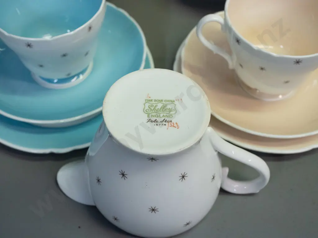 Shelley Pole Star tea ware - 9 trios, cake plate, cream & sugar with a plastic over wire stand. Slight scratch to cake Image 1++