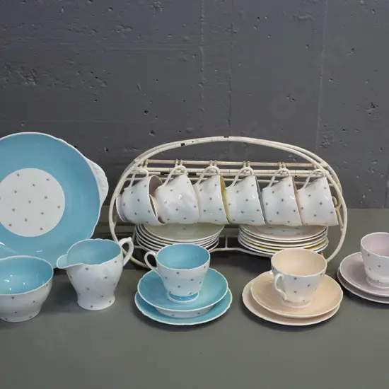 Shelley Pole Star tea ware - 9 trios, cake plate, cream & sugar with a plastic over wire stand. Slight scratch to cake
