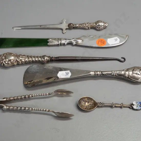 6 cutlery items, 4 hallmarked sterling silver, one knife with greenstone handle, plated sugar tongs and Dutch spoon.