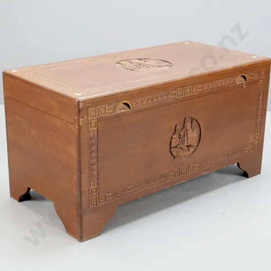 Chinese camphorwood-lined hardwood chest with carved floral decoration & circular carved junk scenes on top and front,