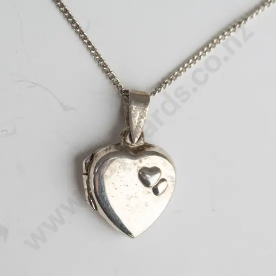silver heart locket with 2 raised heart on front stamped 925
