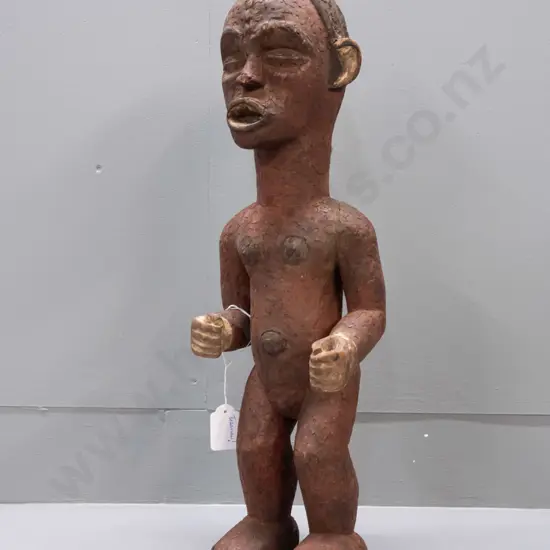 African carved wood standing figure, possibly Tanzania, coloured with earth pigments. Crack / repair to one arm, crazing