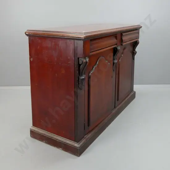 colonial cedar and kauri sideboard with 2 shaped drawers and 2 shield-shaped doors, carved corbels, on plinth base - one