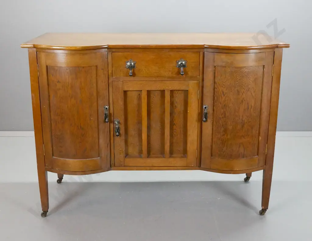 oak sideboard with 2 bowed cupboard doors, central drawer lined with felt, over cupboard door, metal drop handles, Image 1++