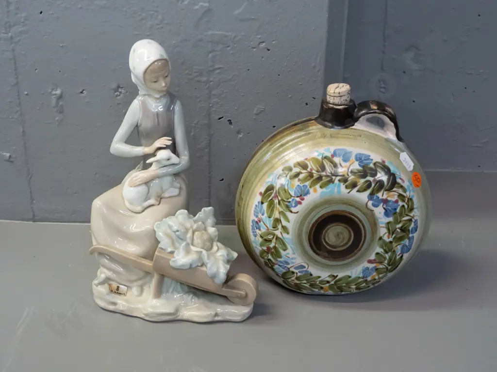 Lladro figurine - woman with lamb and wheelbarrow H-230 and a Greek pottery flask with ring handle and cork stopper. Image 1++