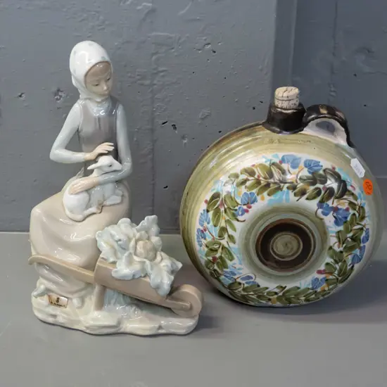 Lladro figurine - woman with lamb and wheelbarrow H-230 and a Greek pottery flask with ring handle and cork stopper.