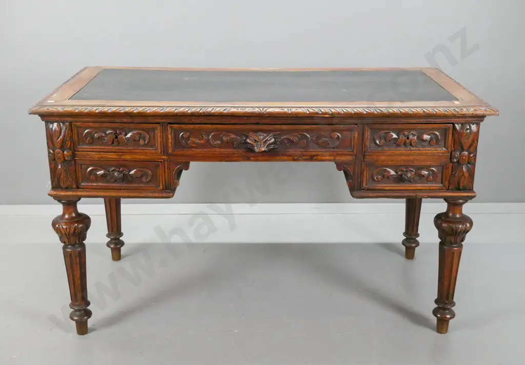 19th century French carved oak desk with carved edge top & drawer fronts, lion's head drawer, fluted and carved legs. Image 1++