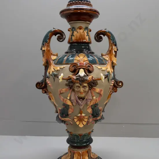 large Wilhelm Schiller & Sons Majolica lidded urn with foliate scrolling handles, acanthus leaf motifs, 2 heads, fluted