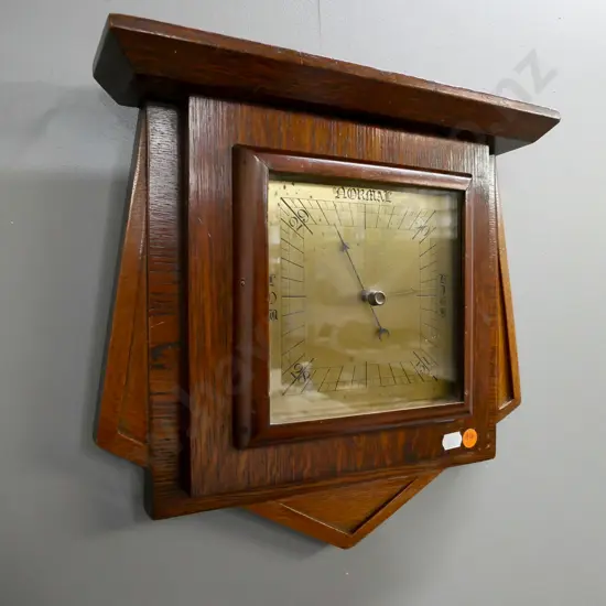 wall-hanging Art Deco oak-cased barometer. Brass face. Some surface wear. H-320, W-320