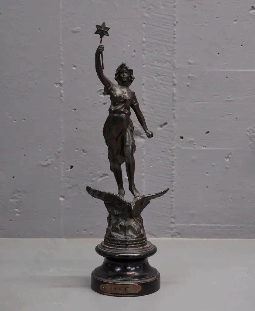 art nouveau maiden figure standing on an eagle holding a star, 'La Nuit'. Rounded wooden base with a plaque. Image 1++